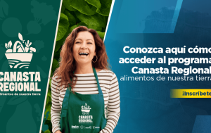 Banner muestra mujer sonriendo, vestida con un delantal verde que dice canasta regional, la pieza gráfica dice: conozca aquí cómo acceder al programa Canasta Regional, alimentos de nuestra tierra, clic para inscribirte