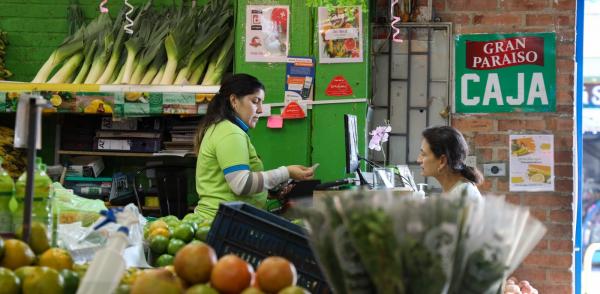 Fotografía de una plaza de mercado en la que se ve a una mujer trabajando
